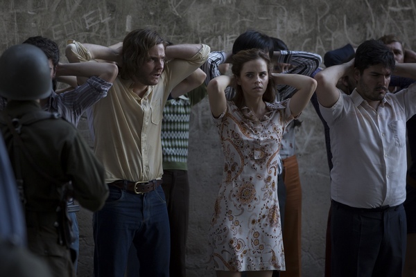 (L to R) Daniel (DANIEL BRÜHL) with Lena (EMMA WATSON) and protestors in “Colonia”.